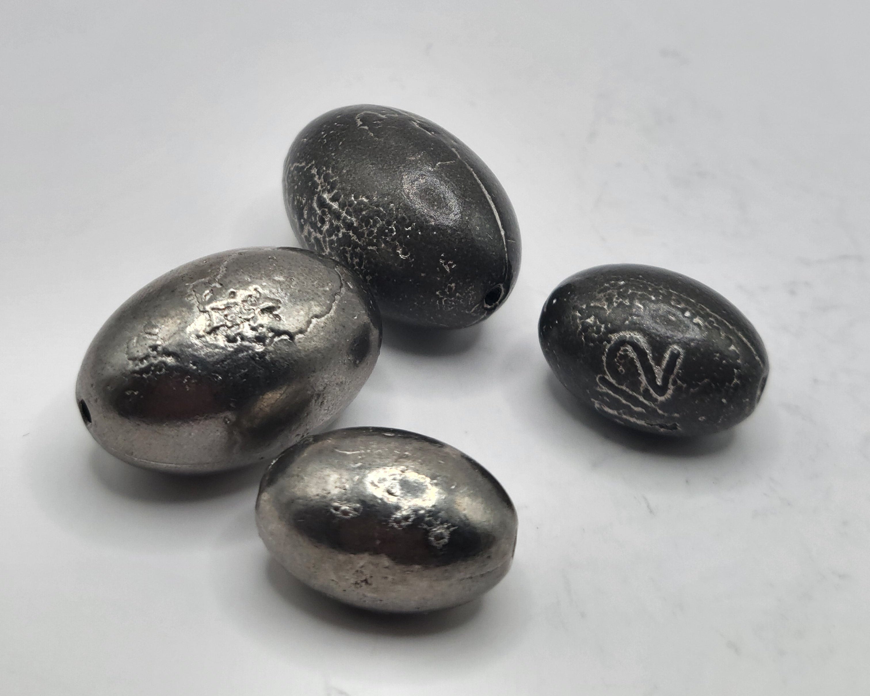 Four fishing egg weights both matte and shiny